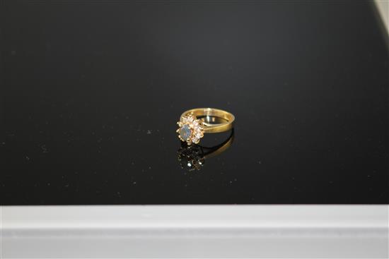 A modern 18k yellow metal, chrysoberyl? and diamond set oval cluster ring, size M, gross weight 4.2 grams.